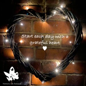 Wall with heart shape woven cane with lights plus quote 'Start each day with a grateful heart'